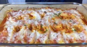 Cheesy baked pasta shells with tomato sauce in a glass dish, topped with fresh parsley. Perfect comfort food!